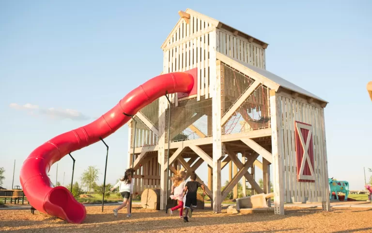 barn playground tower slide natural wood texas ropes nets carvings jpg 768x480
