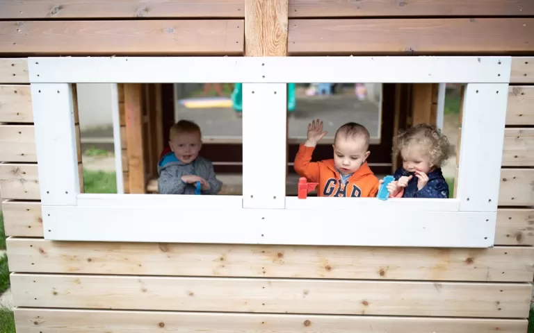 child care daycare outdoor play space playhouse hut natural wood playground jpg 768x480